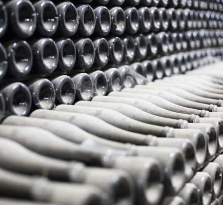 Champagne bottles on riddling racks